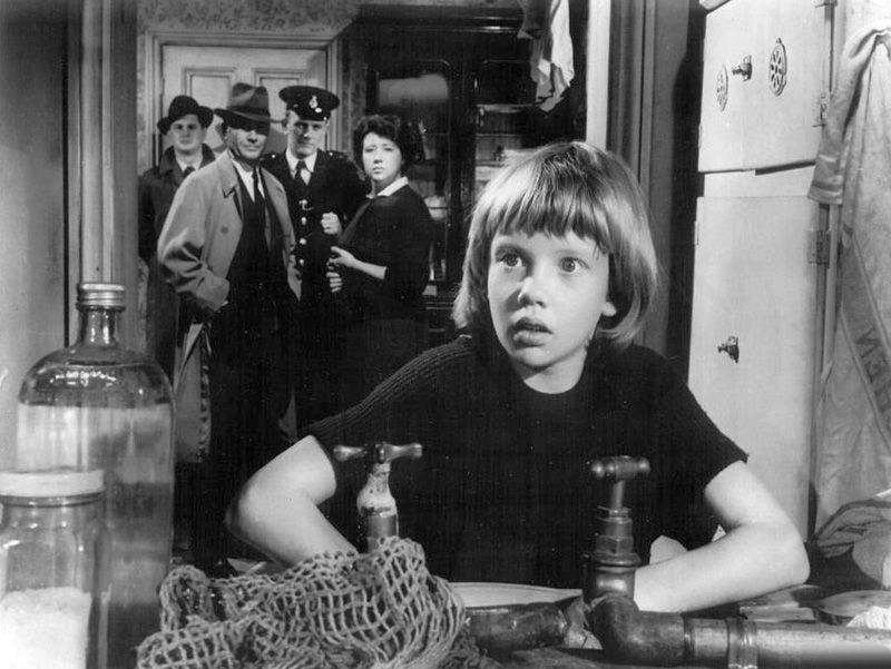 Hayley Mills with father John Mills in the background as police inspector in "Tiger Bay"
