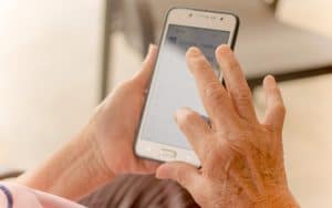 senior with smartphone. Photo by Tai Pu Ngamnil. To work out your body, reach for a set of dumbbells. But to exercise your mind, all you need is a smartphone and good brain-training apps. Image