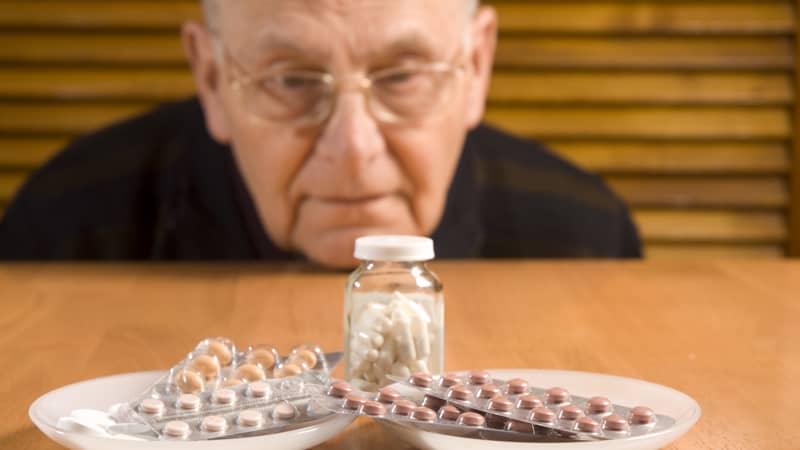 Senior man and his pills Image