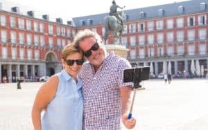 Happy retired senior tourist Couple Standing Taking Selfie in a European city Image