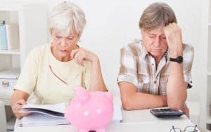Portrait Of Upset Senior Couple Calculating Finance At Home Image