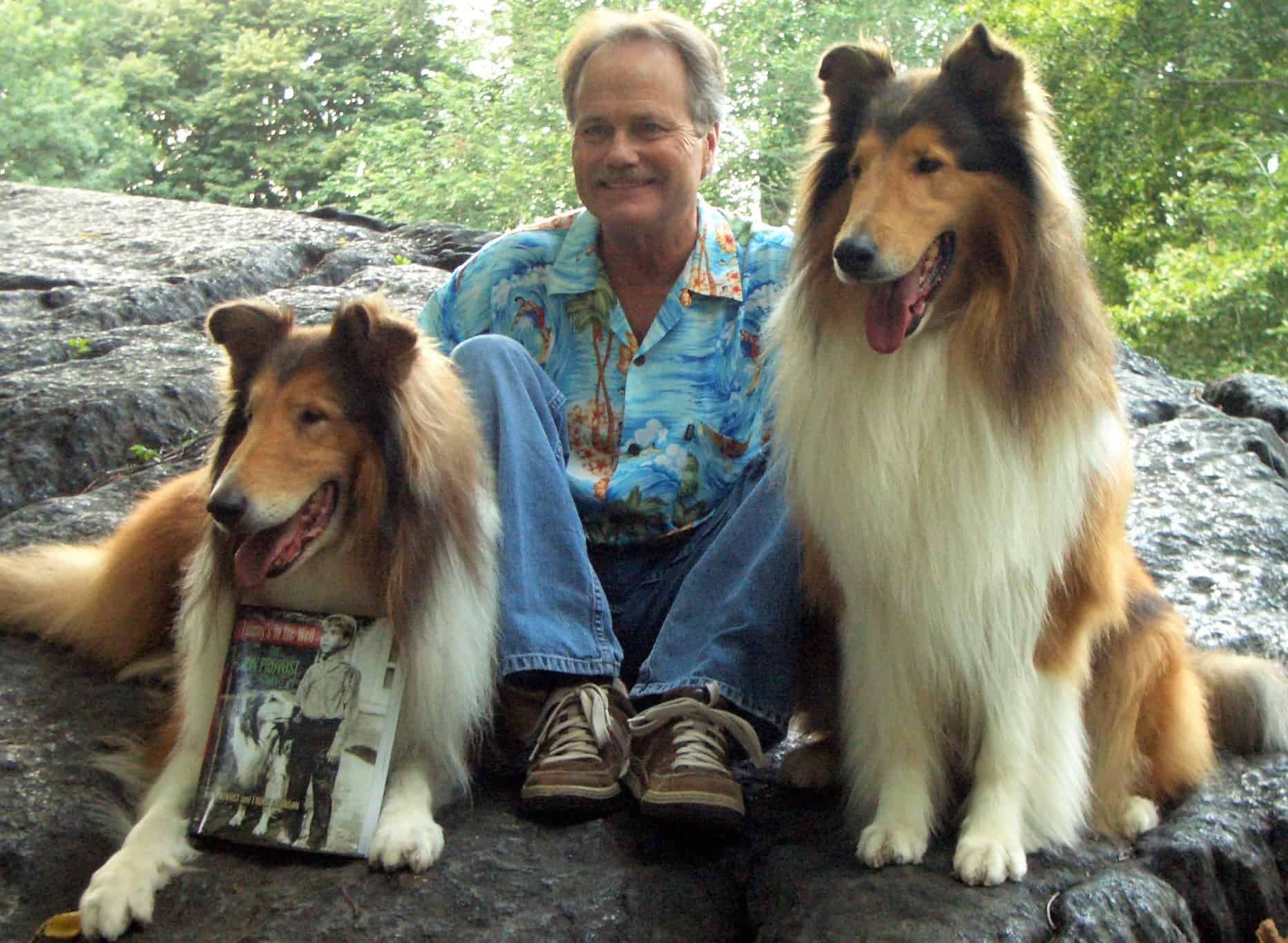 Jon Provost displays a copy of his autobiography with the help of a couple of four-legged friends