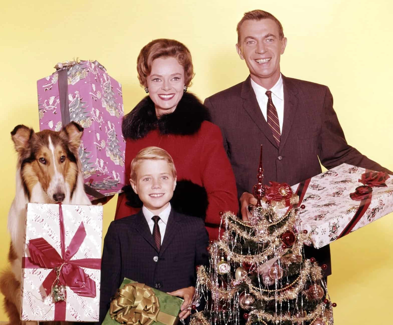 Jon Provost, June Lockhart, Hugh Reilly, and Lassie pose for a Christmas photo