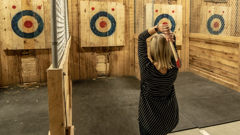 Woman at axe throwing bar in Richmond Image