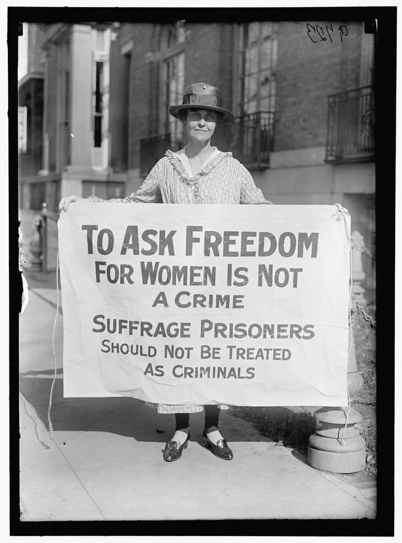 Suffragette holding a sign promoting women's right to vote