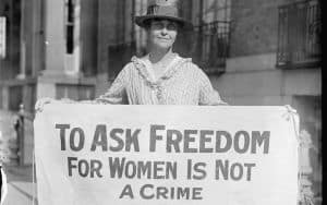 Suffragette holding a sign promoting women's right to vote Image