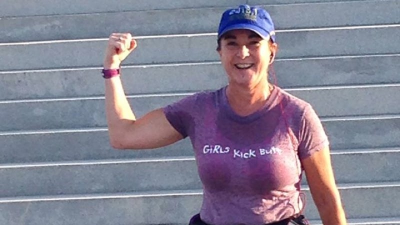 Christine Martine poses with a cool "Girls Kick Butt" shirt after the Monument Avenue 10K