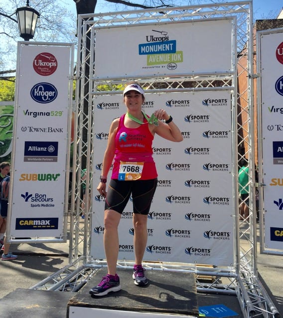 Christine Martine with a winning medal at the Monument Avenue 10K