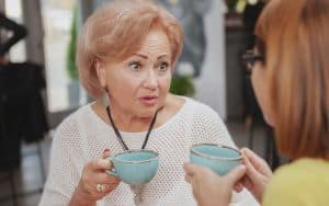 Two mature women drinking tea and gossiping Image