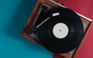 Retro vinyl record player on red-blue background. Top view Image
