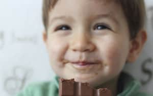 Little boy eating chocolate Image