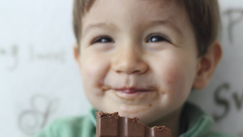 Little boy eating chocolate