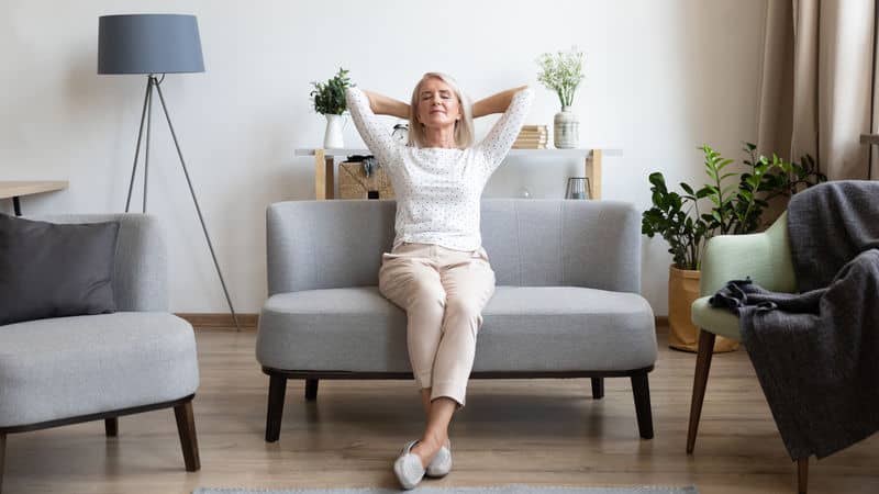 Older woman sits in a calmer home Image