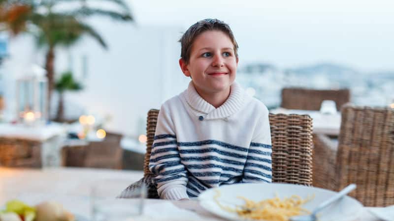 Teenager at the table with bad table manners Image