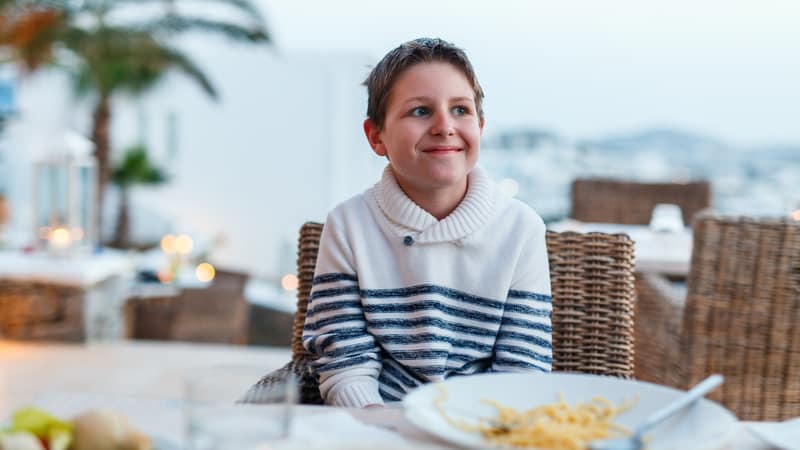 Teenager at the table with bad table manners