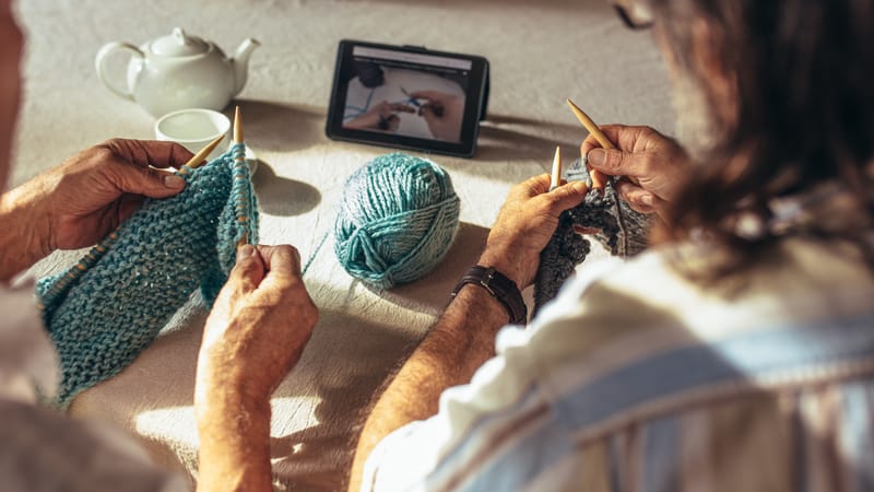 Two seniors learning knitting from home