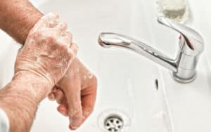 Senior practices good hygiene with handwashing Image