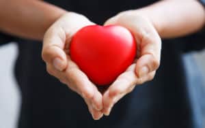 So, woman is holding her heart in her hands Image