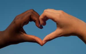 Two different hands creating a heart Image