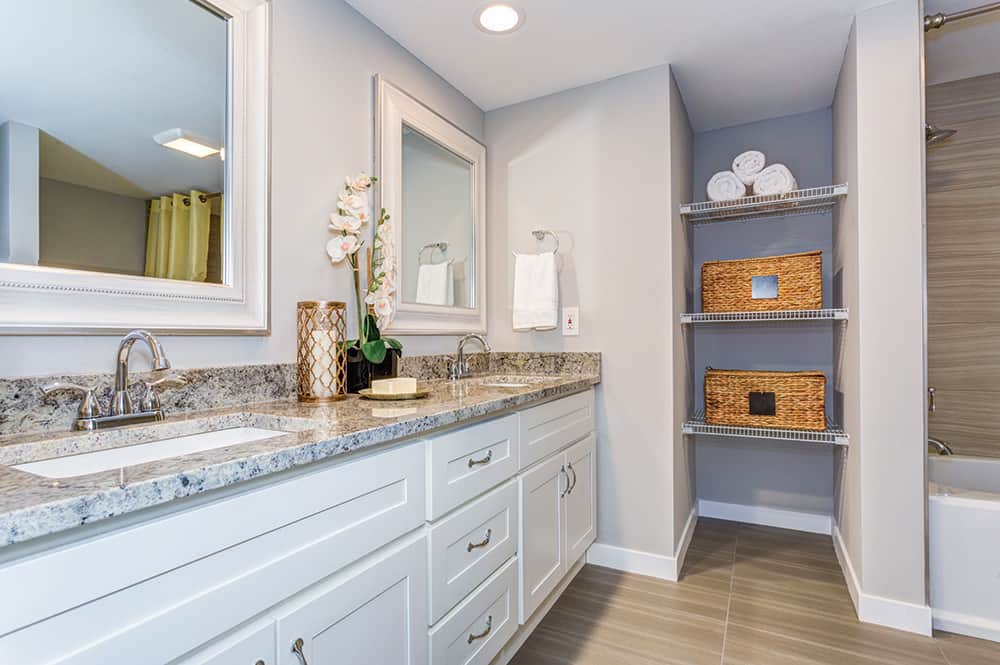 This bathroom has shelving and baskets for organization