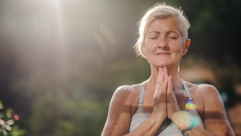 Senior woman doing yoga in her she shed