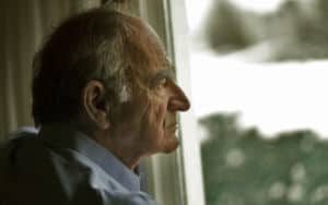 A father looks out the window contemplating his life Image