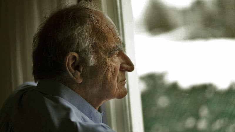 A father looks out the window contemplating his life Image