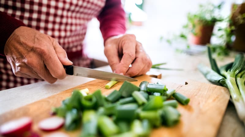 Senior works on meal preparation for healthier choices