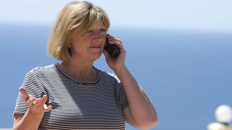 Senior woman getting scammed by fraudulent contact tracers Image
