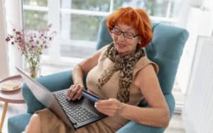 Woman doing some online shopping that gets her into debt Image