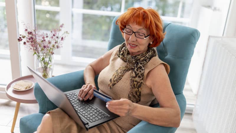 Woman doing some online shopping that gets her into debt Image