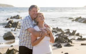 Happy couple hugging, discovering the fountain of youth. Photo by Ocusfocus Image