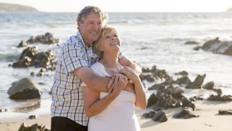 Happy couple hugging, discovering the fountain of youth. Photo by Ocusfocus Image