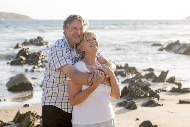 Happy couple hugging, discovering the fountain of youth. Photo by Ocusfocus