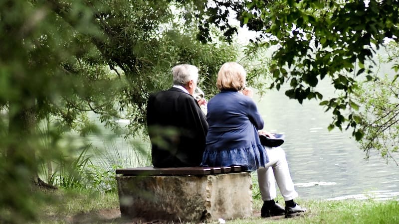 older couple gazing at lake can enjoy boomer retirement preparation