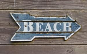 Sign pointing to the beach summons childhood beach memories Image