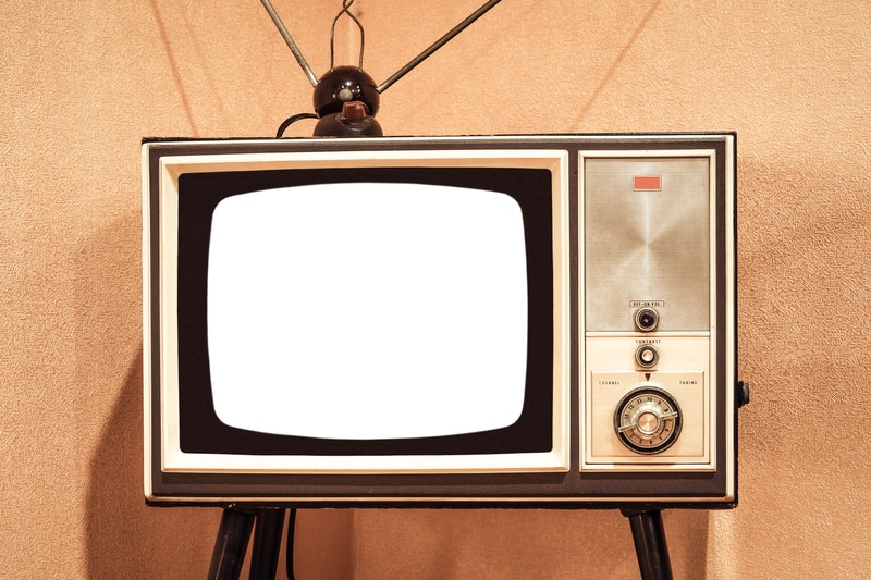 Vintage TV with rabbit ears to promote 10 ad jingles of the 1970s
