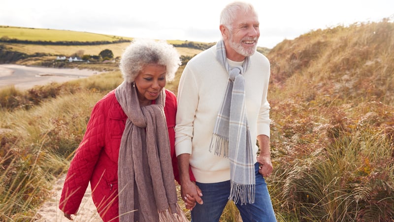 Two seniors walking in the winter health