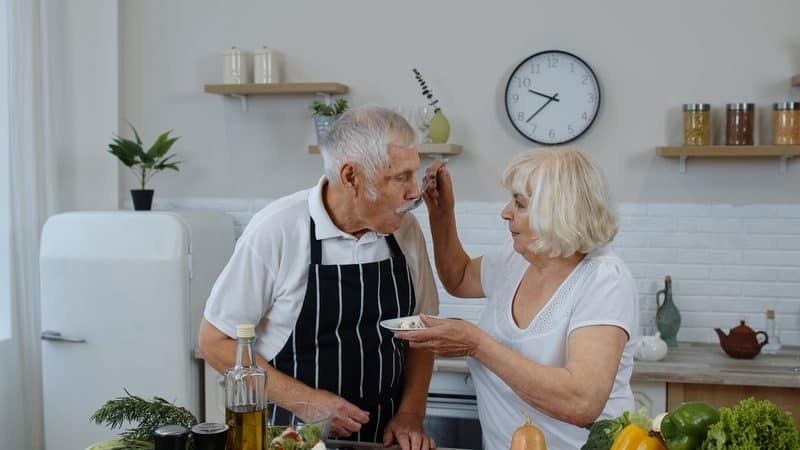 Two seniors eating food for weight loss Image