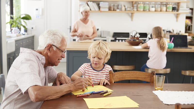 Seniors with grandkids in kitchen for "Kitchen Remodeling Tips for Aging in Place"