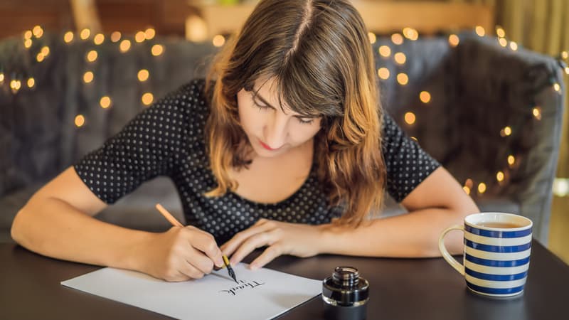 Millennial writing a thank you note