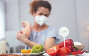 Woman with allergies at a dinner party Image