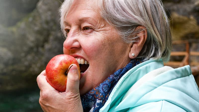 One of the healthiest people eating an apple Image