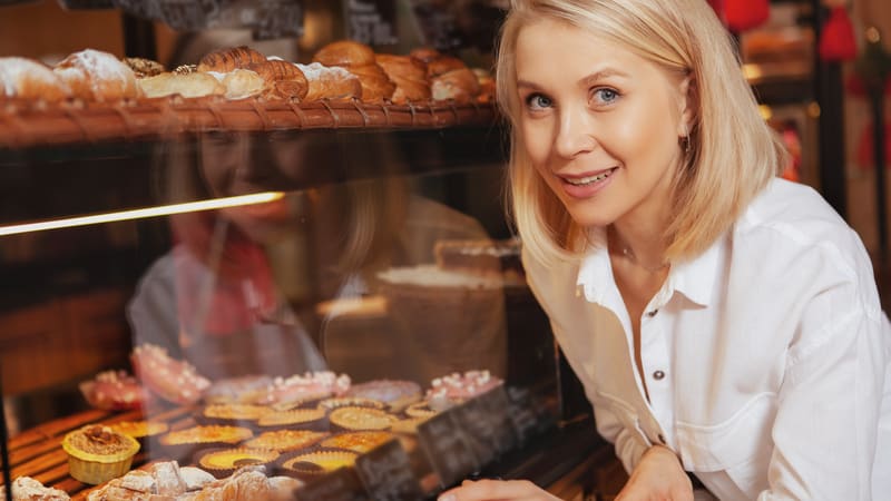 Woman at the bakery in front of bread