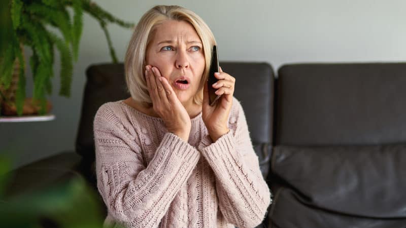 Senior woman expresses her COVID concerns over the phone Image