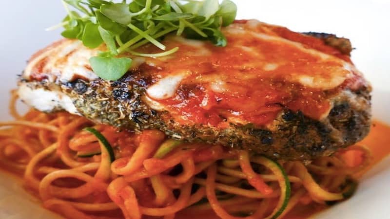 Healthy grilled chicken parmesan over spiral zucchini and whole wheat spaghetti, from Hilton Head Health
