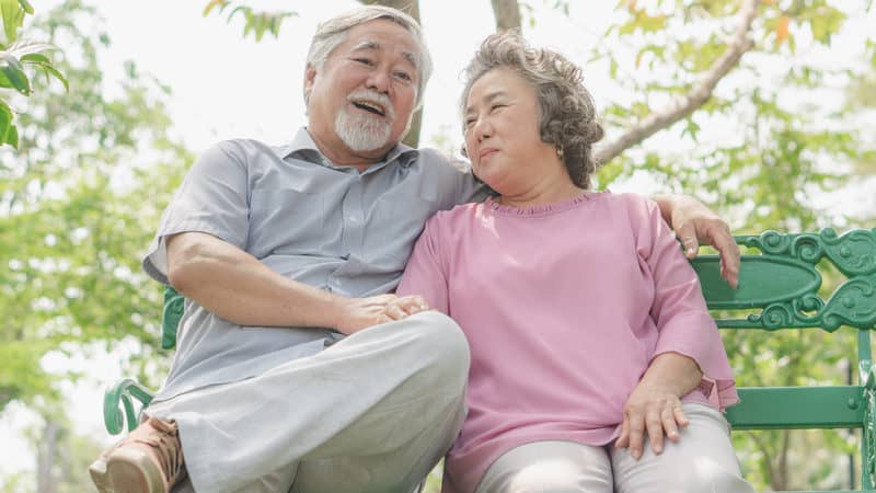 Senior couple sitting on a bench before breakfast Image