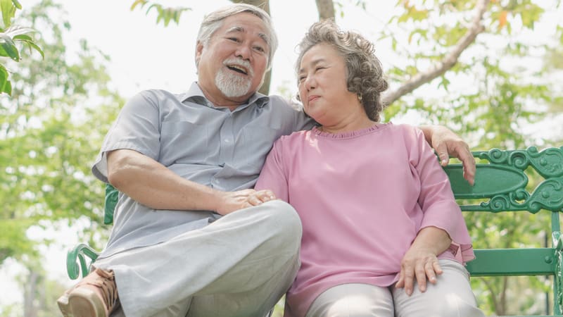 Senior couple sitting on a bench before breakfast