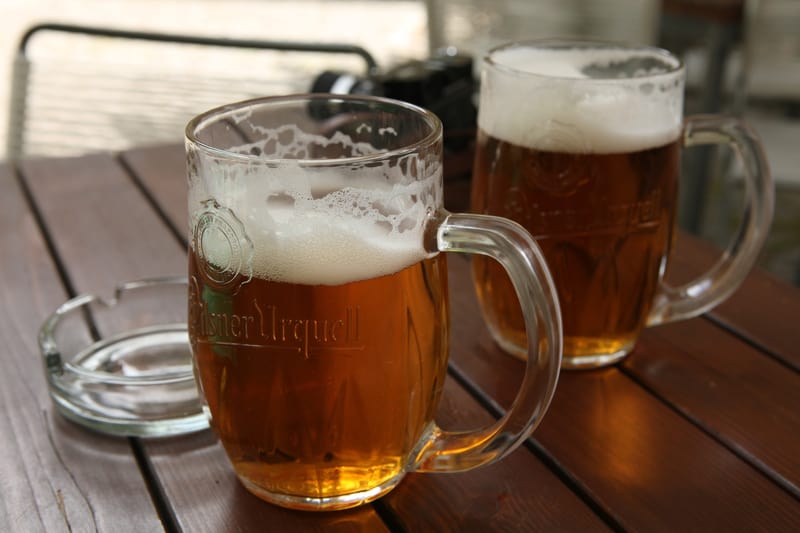 Pilsner Urquell in traditional beer mugs in Prague 