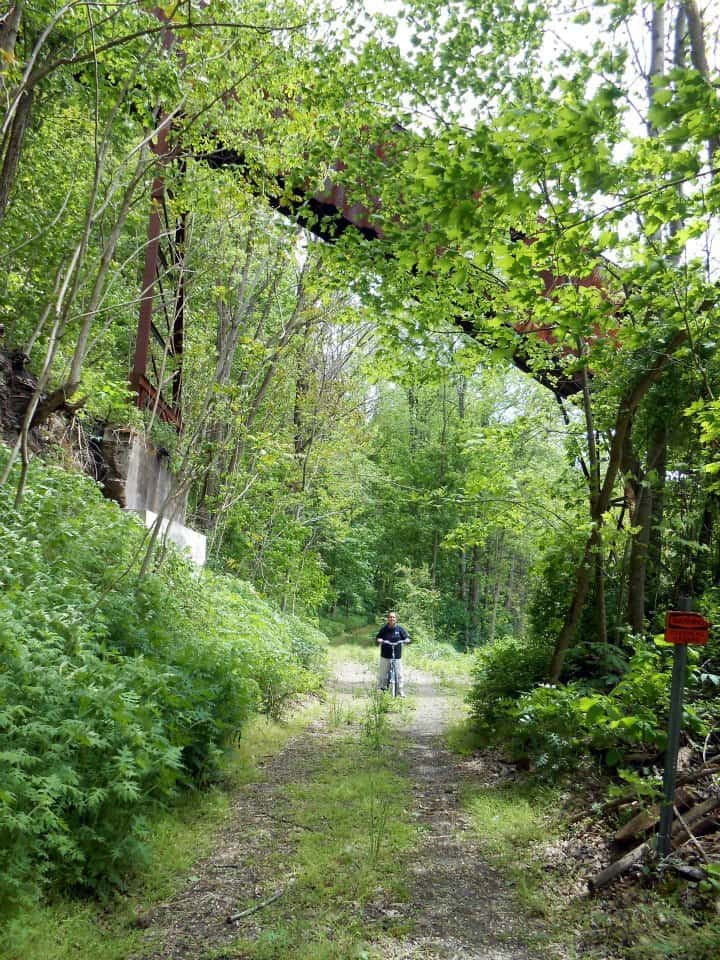 A bicyclist under an old coal conveyor at Nuttallburg in America's newest national park. NPS Dave Bieri